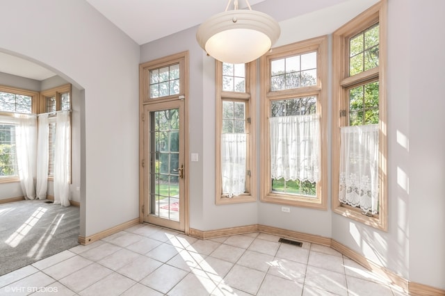 entryway with plenty of natural light and light tile patterned flooring