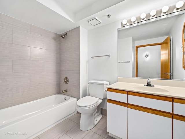 full bathroom featuring tiled shower / bath combo, vanity, toilet, and tile patterned flooring