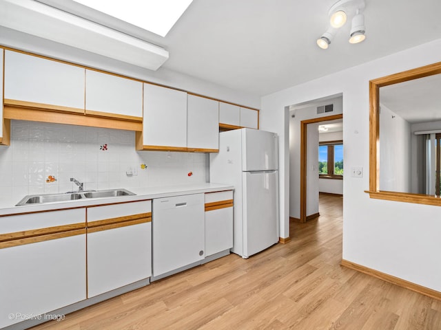 kitchen featuring white cabinets, white appliances, decorative backsplash, and light hardwood / wood-style floors