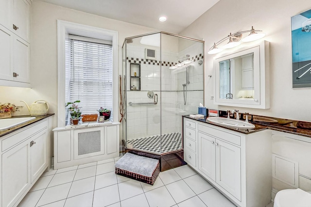 bathroom with vanity, walk in shower, and tile patterned floors