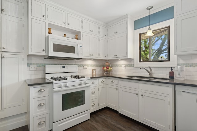 kitchen with white appliances, white cabinetry, sink, dark wood-type flooring, and pendant lighting