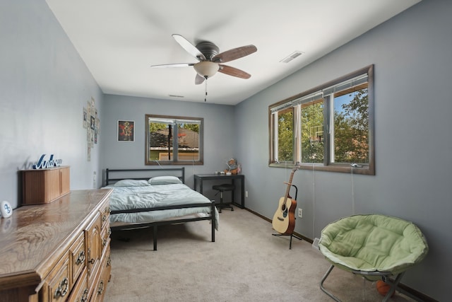 bedroom with ceiling fan and light carpet