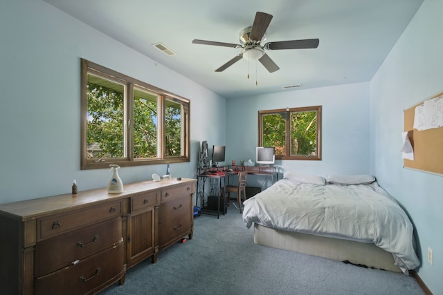 carpeted bedroom with ceiling fan and multiple windows