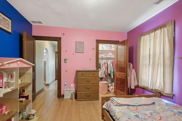 bedroom with light wood-type flooring and a closet