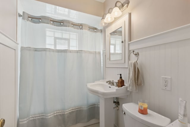 bathroom with toilet and curtained shower