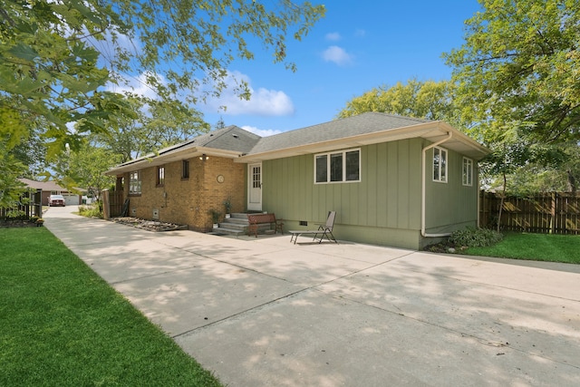 single story home featuring a patio area and a front lawn