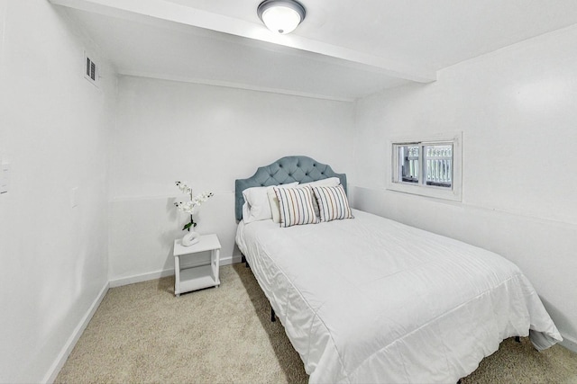 carpeted bedroom featuring beamed ceiling, baseboards, and visible vents