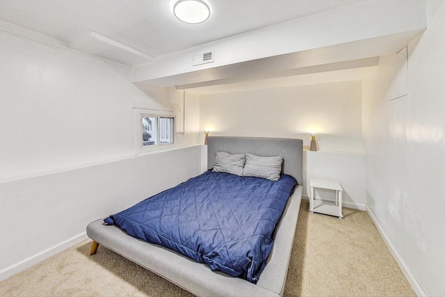 carpeted bedroom featuring baseboards and visible vents