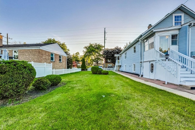 view of yard with stairway and fence