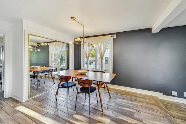 dining space with an inviting chandelier and hardwood / wood-style flooring