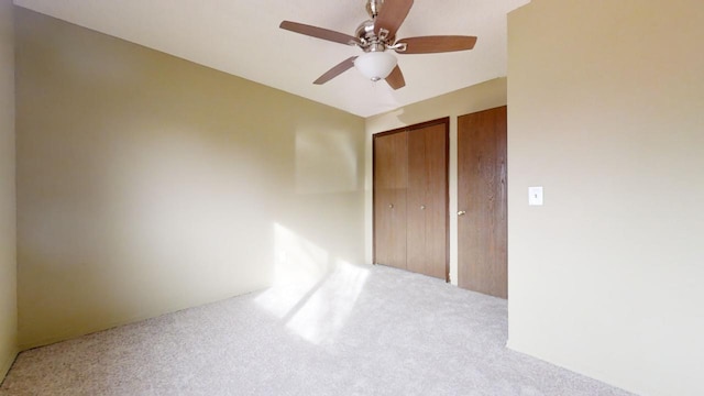 carpeted empty room featuring ceiling fan