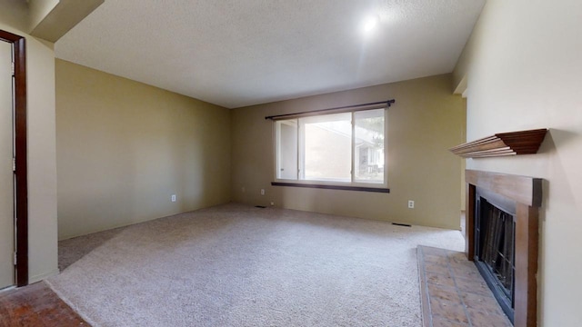 unfurnished living room with light colored carpet and a textured ceiling