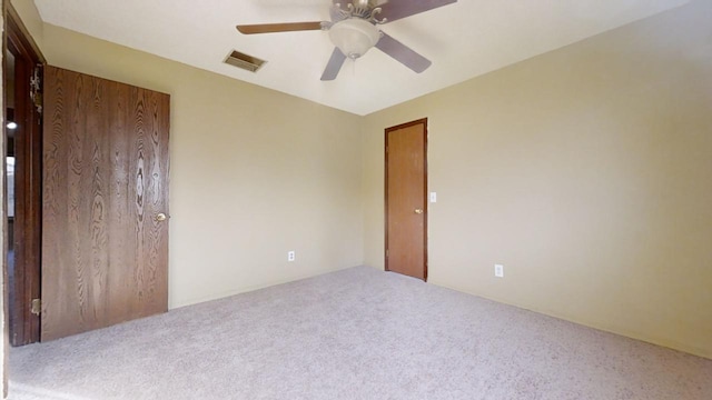 spare room with ceiling fan and carpet floors