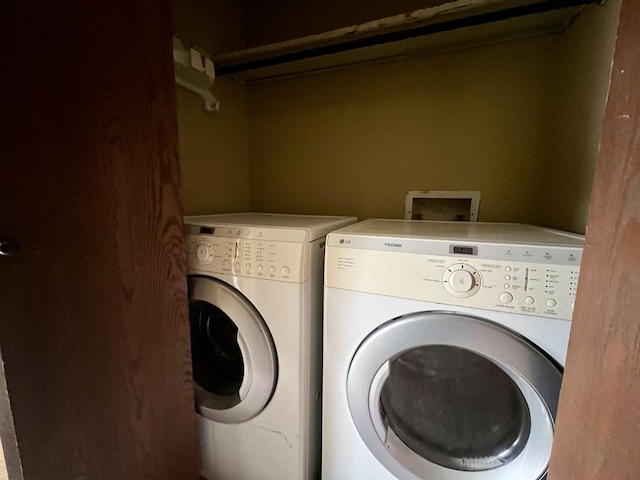 clothes washing area featuring washer and clothes dryer