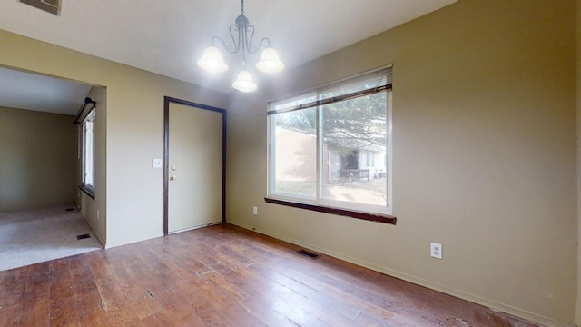 interior space featuring hardwood / wood-style floors and a notable chandelier