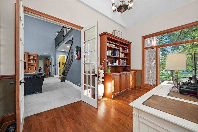 office area featuring a notable chandelier, vaulted ceiling, and wood-type flooring