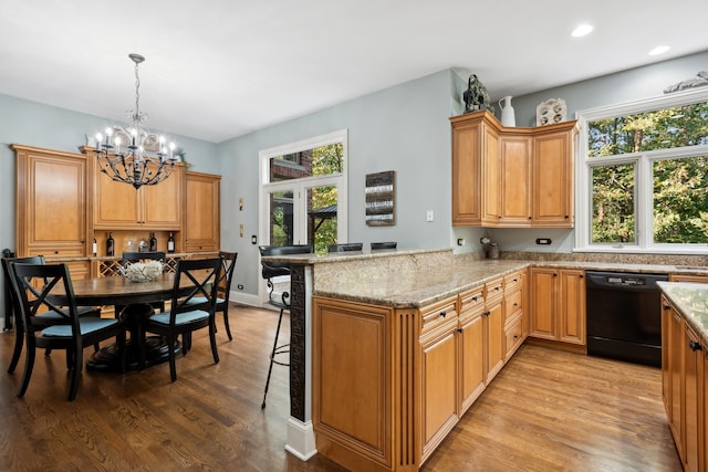 kitchen with dishwasher, kitchen peninsula, light wood-type flooring, and a wealth of natural light