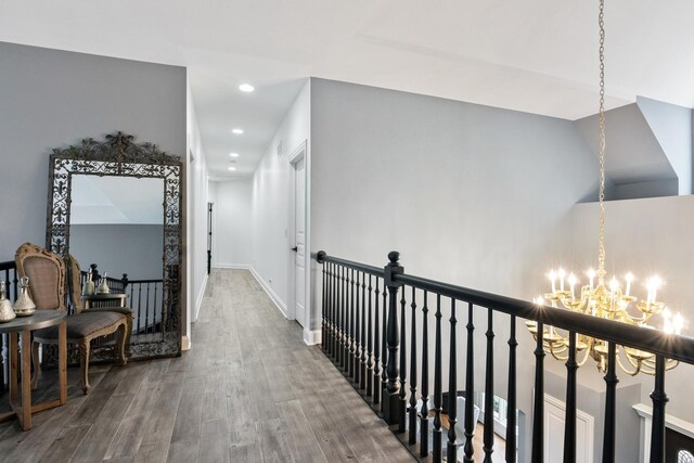 bedroom featuring light hardwood / wood-style flooring, a tray ceiling, and multiple windows