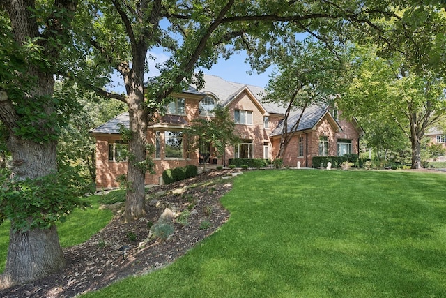 tudor-style house with a front yard