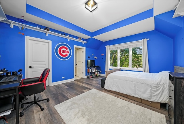 bedroom featuring dark wood-type flooring and vaulted ceiling