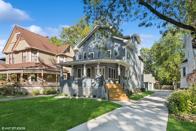 victorian house with a garage, cooling unit, a front lawn, and covered porch