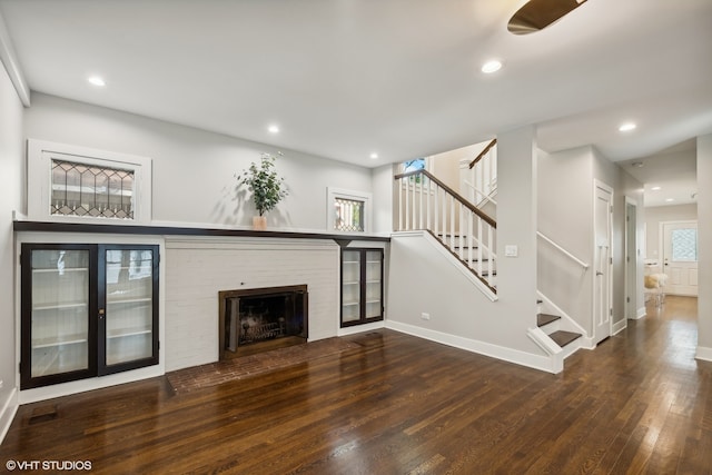 unfurnished living room with a fireplace and hardwood / wood-style floors