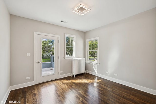 doorway to outside featuring radiator and dark wood-type flooring