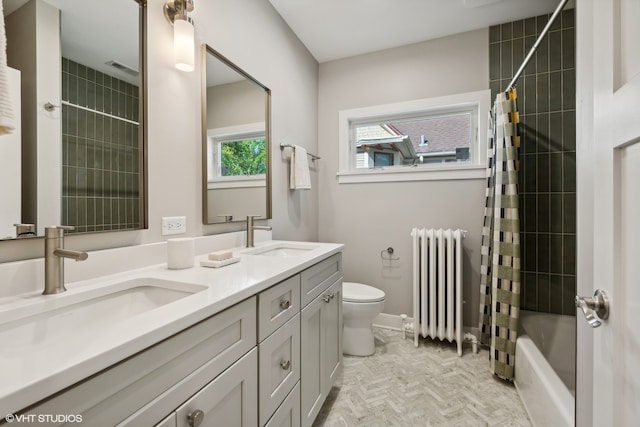 full bathroom with radiator, vanity, shower / tub combo, and toilet