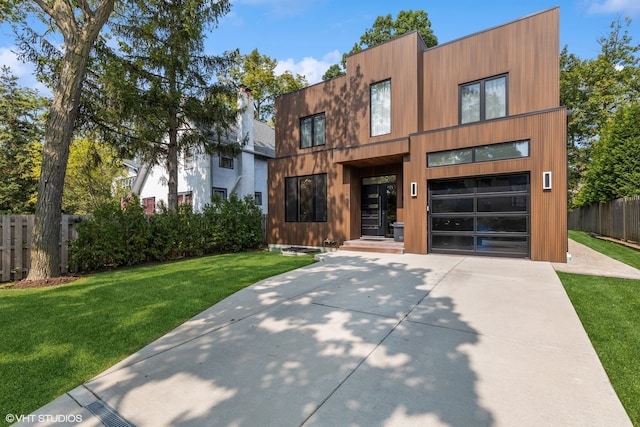 view of front of home featuring a garage and a front yard