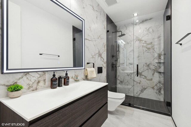 bathroom featuring a shower with shower door, toilet, and vanity