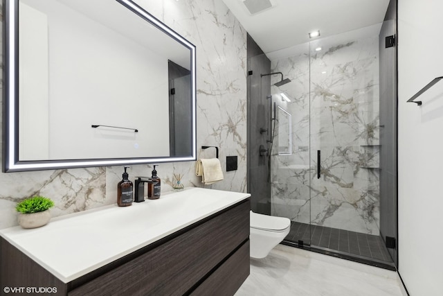 full bath with a marble finish shower, toilet, marble finish floor, and vanity