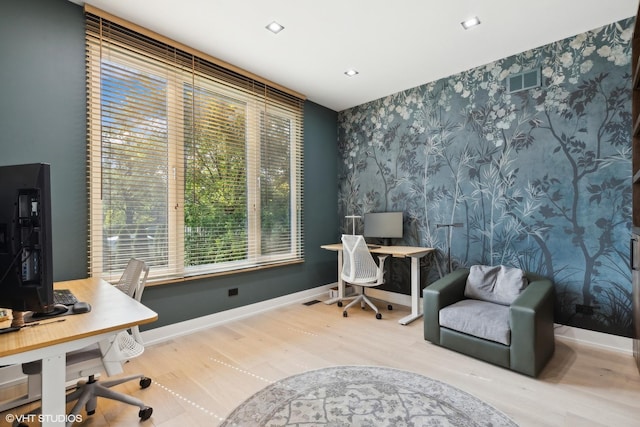 office space featuring wallpapered walls, visible vents, wood finished floors, and baseboards