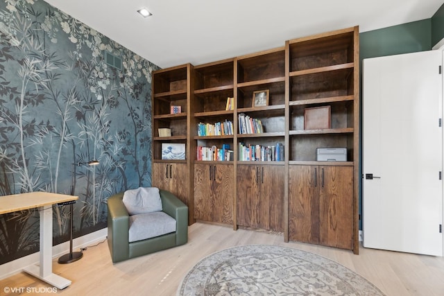 sitting room featuring visible vents, wallpapered walls, baseboards, and wood finished floors