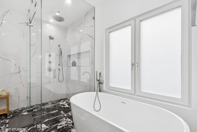 full bathroom with marble finish floor, a marble finish shower, and a freestanding bath