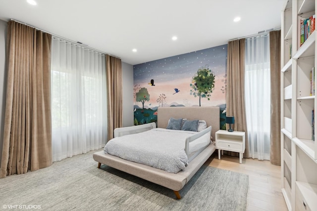 bedroom featuring recessed lighting, wallpapered walls, and wood finished floors