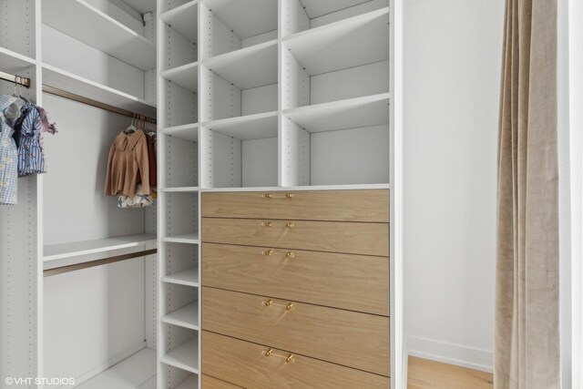 spacious closet with light hardwood / wood-style floors