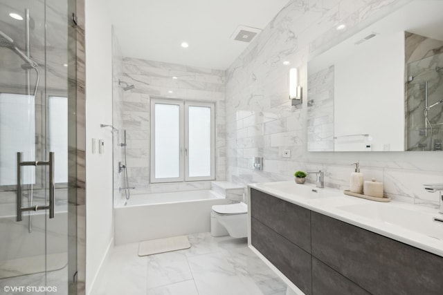 full bathroom with a sink, a shower stall, tile walls, toilet, and marble finish floor