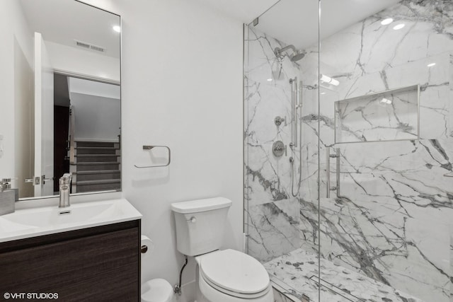full bathroom featuring a marble finish shower, visible vents, toilet, and vanity