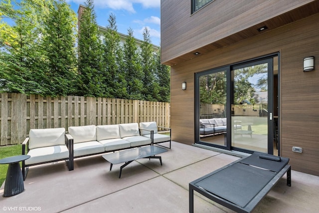 view of patio with outdoor lounge area and fence