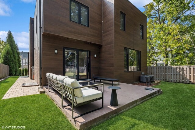 back of property featuring a patio area, a yard, outdoor lounge area, and central AC