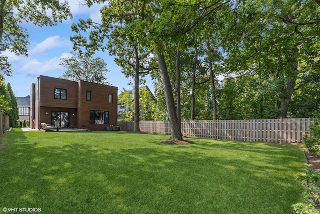 view of yard with cooling unit and a fenced backyard