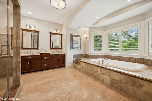 bathroom featuring vanity and plus walk in shower