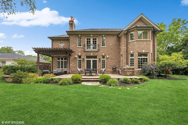 rear view of property featuring a pergola, a yard, and a patio