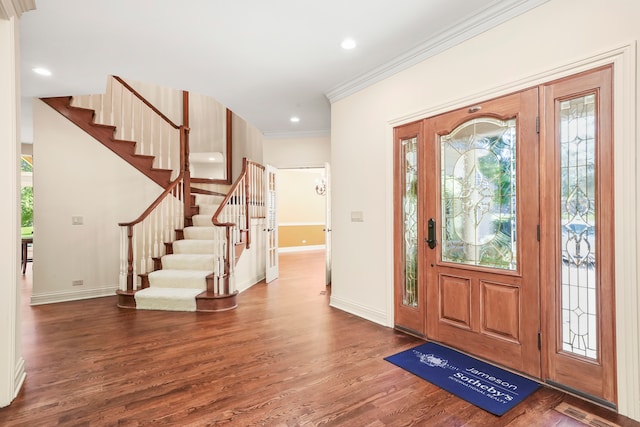 foyer featuring dark hardwood / wood-style flooring and ornamental molding