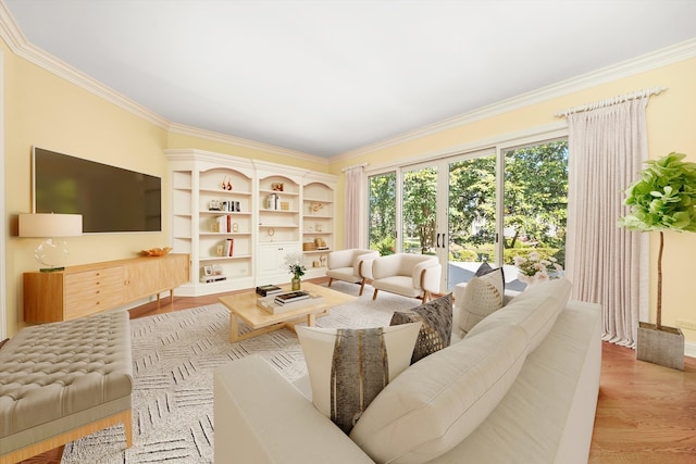 living room featuring french doors, crown molding, and light hardwood / wood-style flooring