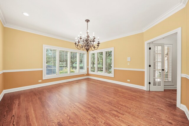 unfurnished dining area featuring an inviting chandelier, a healthy amount of sunlight, and ornamental molding