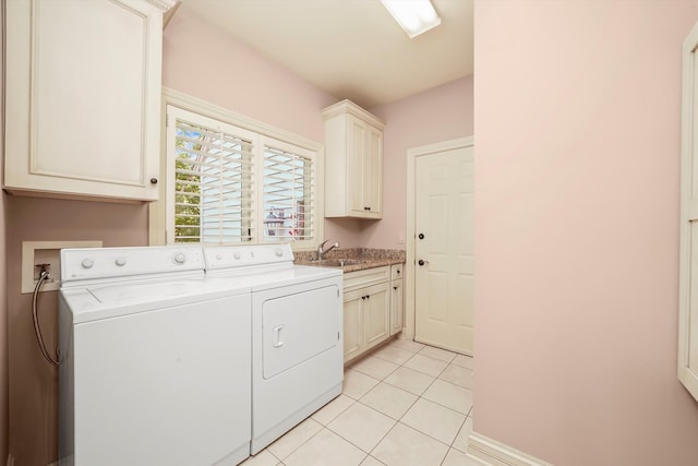 laundry area with independent washer and dryer, cabinets, light tile patterned flooring, and sink