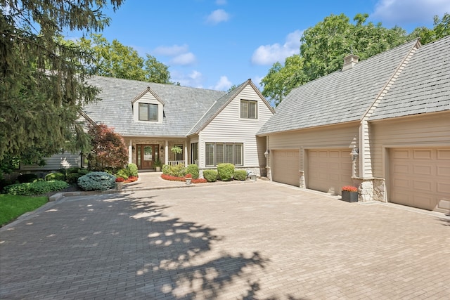 cape cod home with a garage