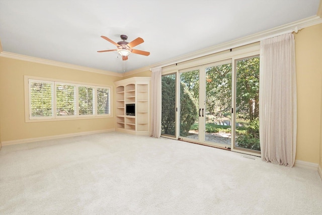 unfurnished living room featuring light carpet, crown molding, and ceiling fan