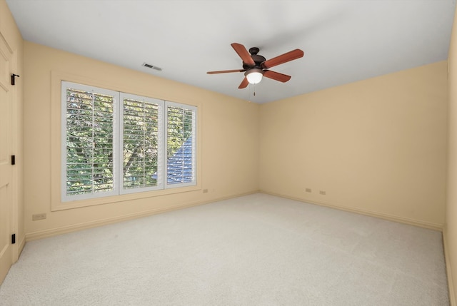 carpeted spare room with ceiling fan